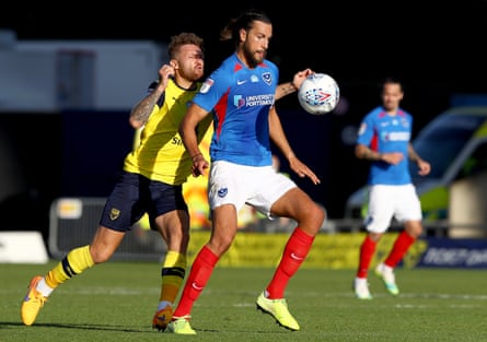 Christian Burgess holds off Matty Taylor of Oxford while playing for Portsmouth in the League One playoffs in 2020.