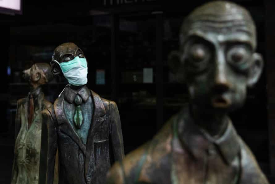 A face mask on a statue in Swanston Street, Melbourne