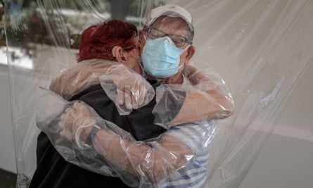 Relatives embrace through plastic deviceepa08490430 A woman (L) embraces her nephew (R) through a plastic device after three months without a hug at a home for the elderly in Valencia, Spain, 17 June 2020, amid the ongoing coronavirus pandemic. EPA/BIEL ALINO