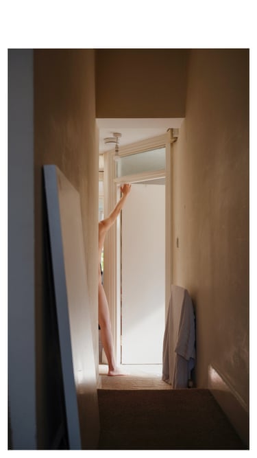 Half of a nude figure at the end of a corridor