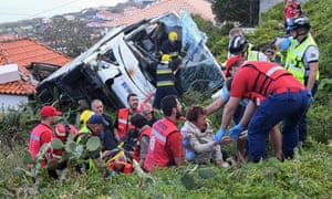 Firemen help victims of the crash on the Portuguese island of Madeira