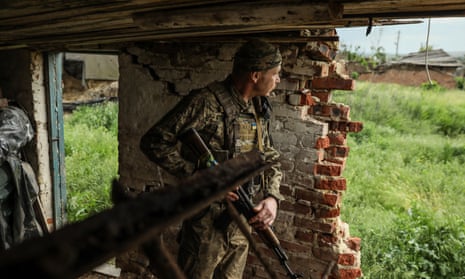 A Ukrainian serviceman from the 24th Separate Mechanized Brigade 'King Danylo' keeps watch at a frontline position, at an undisclosed location in the Donetsk region, eastern Ukraine, 24 May 2023, amid the Russian invasion. 