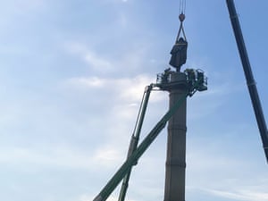 Workers remove a statue of John C. Calhoun