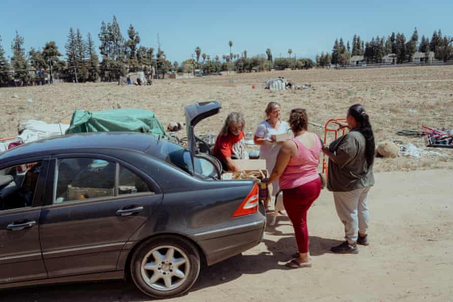 Four women standing near a car