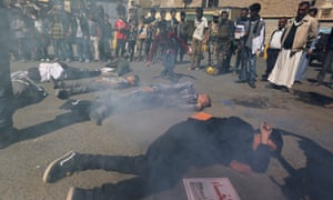 Yemenis play the victims of an airstrike during a protest against ongoing Saudi-led coalition military operations.