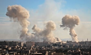 Smoke rises from buildings following bombardment on the village of Mesraba in the rebel-held besieged eastern Ghouta region.