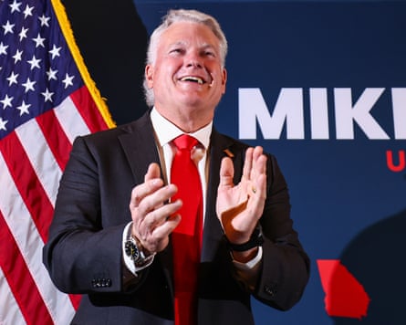 Mike Collins clapping successful beforehand of a US flag.