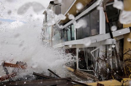 waves of water hitting houses
