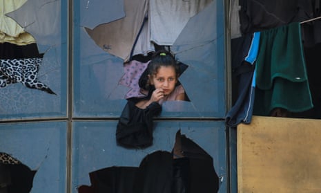 A Palestinian girl stands at a tent in a camp sheltering displaced Palestinians in Khan Younis.