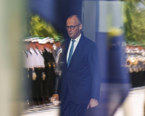 German chancellor Friedrich Merz is seen through a window at the Chancellery in Berlin, Germany.