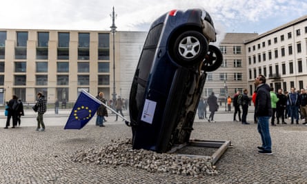 A car installed to look like it is crashing vertically into the ground