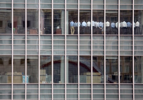 Staff, seen from outside, stand by the window in a meeting room at Lehman Brothers offices in the financial district of Canary Wharf in London September 11 2008.