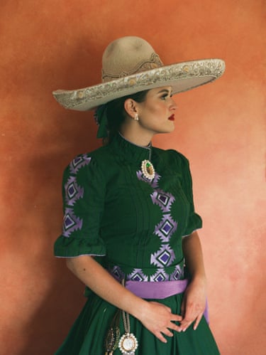 A woman in traditional dress looks away from the camera
