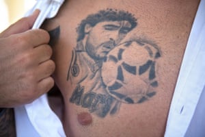A young Neapolitan fan, born during the golden age of Maradona, reveals a tattoo of his idol