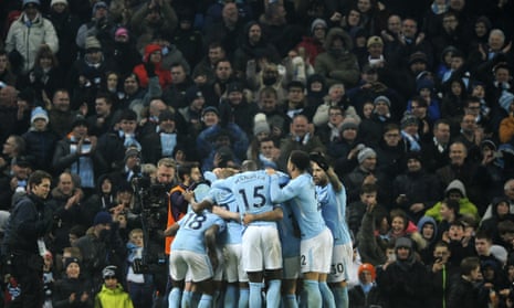 Manchester City players celebrate their team’s third goal.
