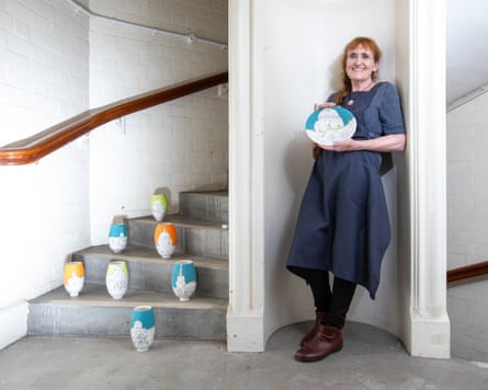Linda Pitcher with a collection of her pottery.