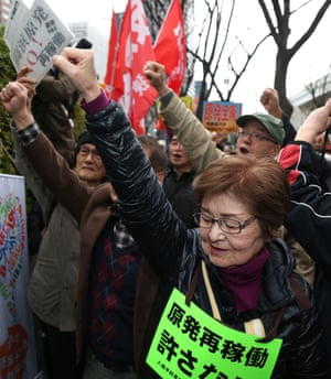 Anti-nuclear protesters stage a rally outside the Osaka high court.