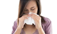 Woman wiping her nose with a tissue