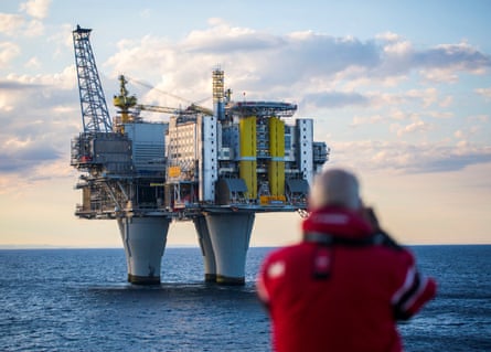 A man looks on oil platform during a cruise in the North Sea, Norway