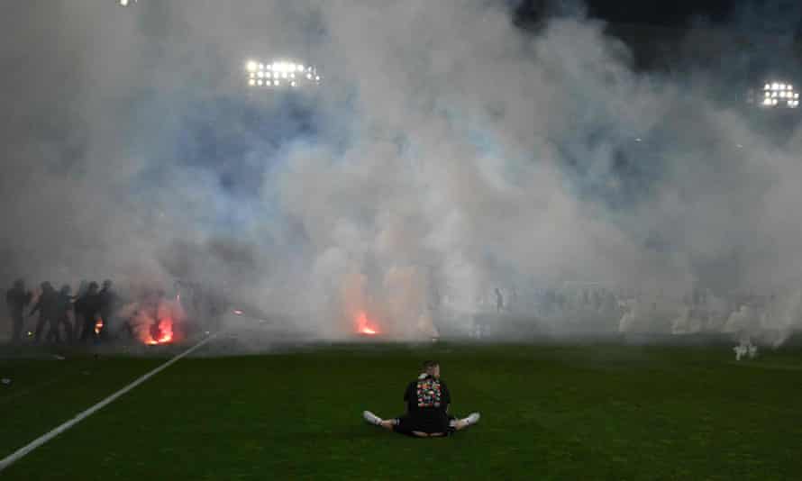 St-Étienne fan sits on the pitch after the final.
