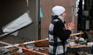 A woman reacts as she looks on at the destruction in Lviv.