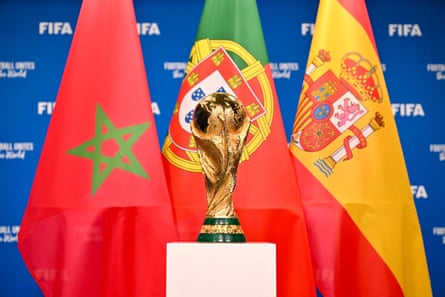 The World Cup stands in front of the flags of Morocco, Portugal and Spain.
