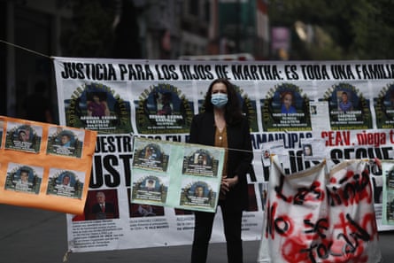 A journalist stands amid signs calling for justice for victims outside the human rights commission building in Mexico City on 8 September.