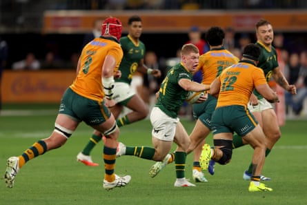 Desperate Wallabies players attempt to hold off Morne van den Berg