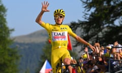 Tadej Pogacar celebrates as he crosses the line at the summit of the Col de la Couillole.