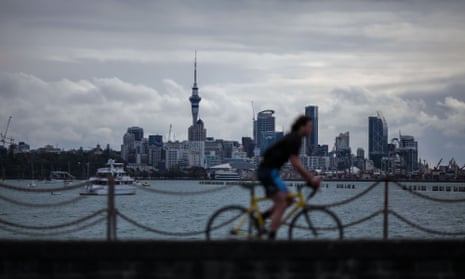 A man rides a bicycle at Mission Bay in Auckland, New Zealand