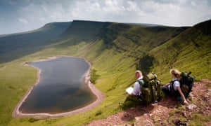 Walkers at Llyn y Fan Fach in the Brecon Beacons National Park at Powys, Wales