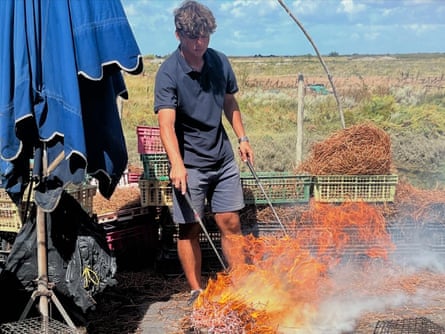 A man cooking seafood outside in rural France.