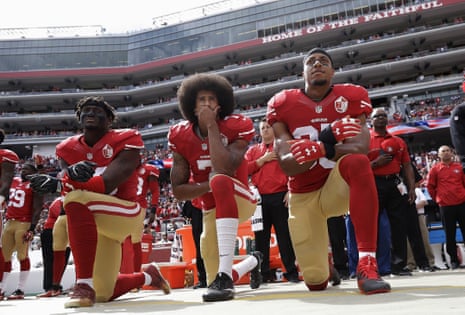 San Francisco 49ers outside linebacker Eli Harold, left, quarterback Colin Kaepernick, center, and safety Eric Reid kneel during the national anthem before an NFL football game against the Dallas Cowboys