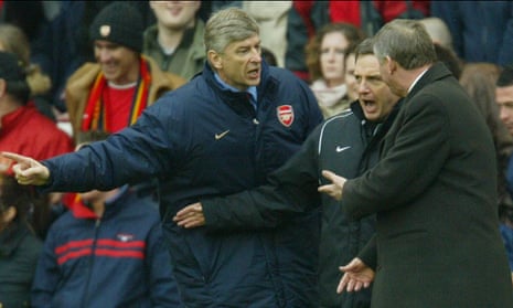Arsène Wenger and Sir Alex Ferguson have to be separated by fourth official Alan Wiley during an Arsenal and Manchester United match at Highbury in March 2004