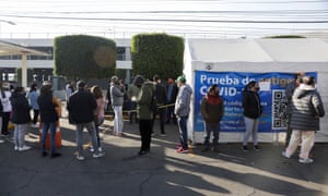 People queue to be tested for coronavirus in the parking lot of a Walmart, in Mexico City, Mexico.