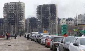 A view shows a line of cars near blocks of flats destroyed during Ukraine-Russia conflict, as evacuees leave the besieged port city of Mariupol, Ukraine March 17, 2022.