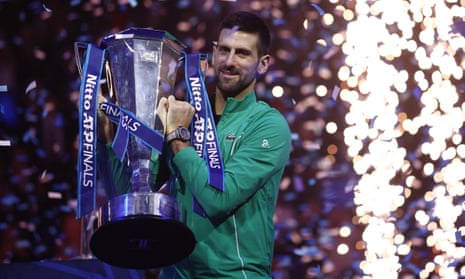 Novak Djokovic celebrates with the trophy after beating Italy's Jannik Sinner