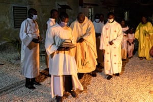 A priest and his congregation make their way towards a fire during the Easter vigil