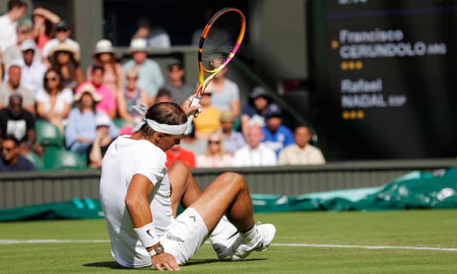 Rafael Nadal slips over on Centre Court.