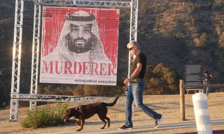 A man walks his dog past an art installation of Mohammed bin Salman in Los Angeles this month to spotlight the murder of the Saudi journalist Jamal Khashoggi.