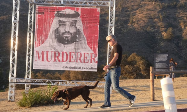 A man walks his dog past an art installation of Mohammed bin Salman in Los Angeles this month to spotlight the murder of the Saudi journalist Jamal Khashoggi us,saudi arabia,Biden,Mohammed bin Salman,Crown Prince Mohammed bin Salman,Jamal Khashoggi,harbouchanews