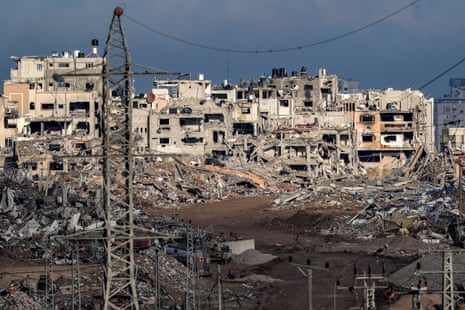 This picture taken on 3 January shows a view of buildings destroyed by Israeli bombardment in the central Gaza Strip from a position across the border in southern Israel.