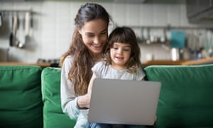 Happy laughing mother and daughter using laptop