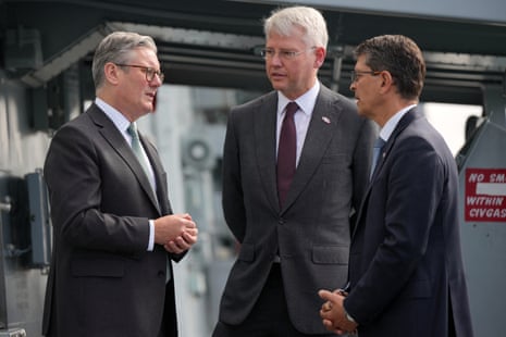 UK prime minister Keir Starmer (L) speaks to Charles Woodburn CEO of BAE (C) and Geir Hoy, CEO of Kongsberg (R) onboard the HMS St Albans in Oslo, Norway.
