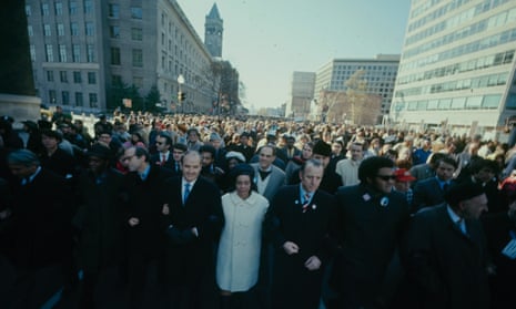 Coretta Scott King, in a white coat, participates in the Moratorium to End the War in Vietnam March in Washington on 15 November 1969.