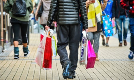 Shoppers on a high street carrying shopping bags
