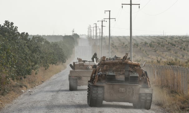 Turkish army tanks moving towards the Syrian border.