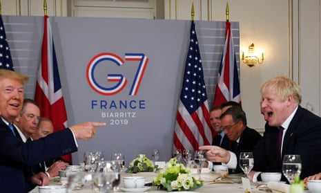 President Donald Trump with the prime minister, Boris Johnson, and others in the background