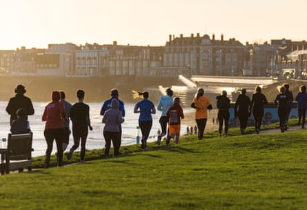 Parkrun runners on the seafront at Whitley Bay, Newcastle upon Tyne.