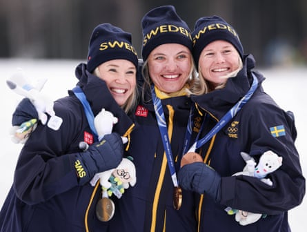 Linn Svahn, Jonna Sundling and Maja Dahlqvist, all of Sweden, pose with their medals after the women’s sprint classic at the 2026 Winter Olympics